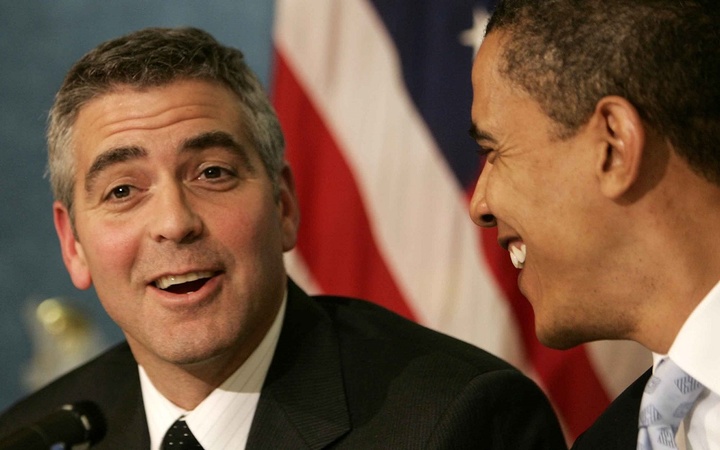 George Clooney smiles alongside Obama at a news conference about his recent visit to the Darfur region of Sudan