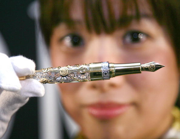 An employee of Swiss luxury stationery maker Caran d'Ache displays the company's 20 million yen (174,000 USD) fountain pen "1010" made with 18-karat gold and studded with a diamond and a ruby, at the Swiss Embassy in Tokyo, 17 October 2007. Caran d"ache produced 10 limited edition models with one piece made available for the Japanese market.     AFP PHOTO / Yoshikazu TSUNO (Photo credit should read YOSHIKAZU TSUNO/AFP/Getty Images)