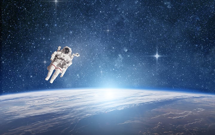 Astronaut in outer space against the planet earth. Elements of this image furnished by NASA.