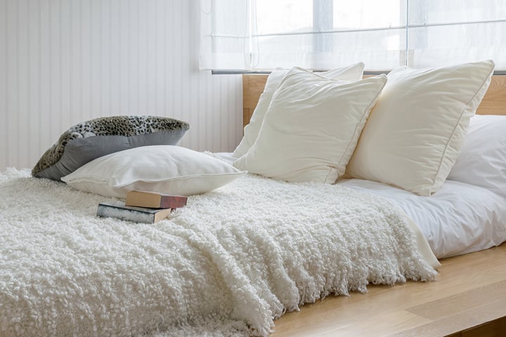 sylish bedroom interior design with black and white pillows on bed.