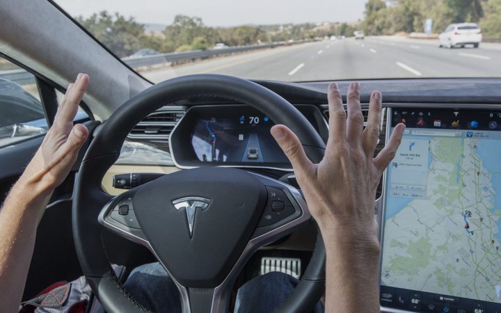 A member of the media test drives a Tesla Motors Inc. Model S car equipped with Autopilot in Palo Alto, California, U.S., on Wednesday, Oct. 14, 2015. Tesla Motors Inc. will begin rolling out the first version of its highly anticipated "autopilot" features to owners of its all-electric Model S sedan Thursday. Autopilot is a step toward the vision of autonomous or self-driving cars, and includes features like automatic lane changing and the ability of the Model S to parallel park for you. Photographer: David Paul Morris/Bloomberg via Getty Images