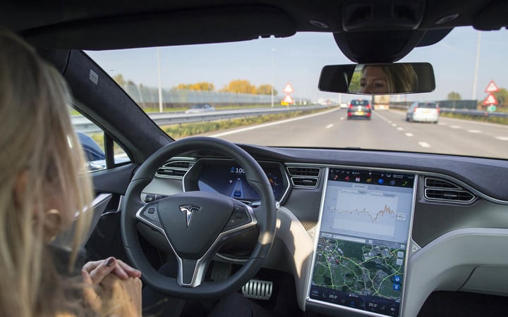 An employee drives a Tesla Motors Inc. Model S electric automobile, equipped with Autopilot hardware and software, hands-free on a highway in Amsterdam, Netherlands, on Monday, Oct. 27, 2015. Tesla started equipping the Model S with hardware -- radar, a forward-looking camera, 12 long-range sensors, GPS -- to enable the autopilot features about a year ago. Photographer: Jasper Juinen/Bloomberg