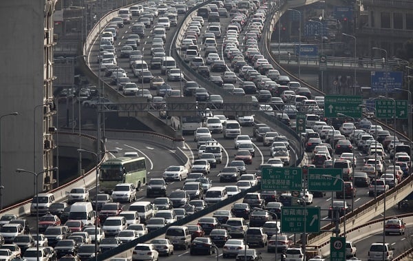 A general view of heavy traffic on a highway during the morning rush hours in Shanghai March 26, 2012. China may be the world's No. 2 oil consumer and have the world's biggest vehicle market but current high oil prices are unlikely to dent growth in fuel demand much or sales of fuel-guzzling sports utility vehicles. The country, which imports 56 percent of the oil it needs, is set to lead global oil demand again this year by contributing nearly half of the world's incremental fuel use, although the pace has slowed. Pictures taken March 26, 2012. REUTERS/Carlos Barria (CHINA - Tags: TRANSPORT ENERGY BUSINESS) - RTR2ZYED
