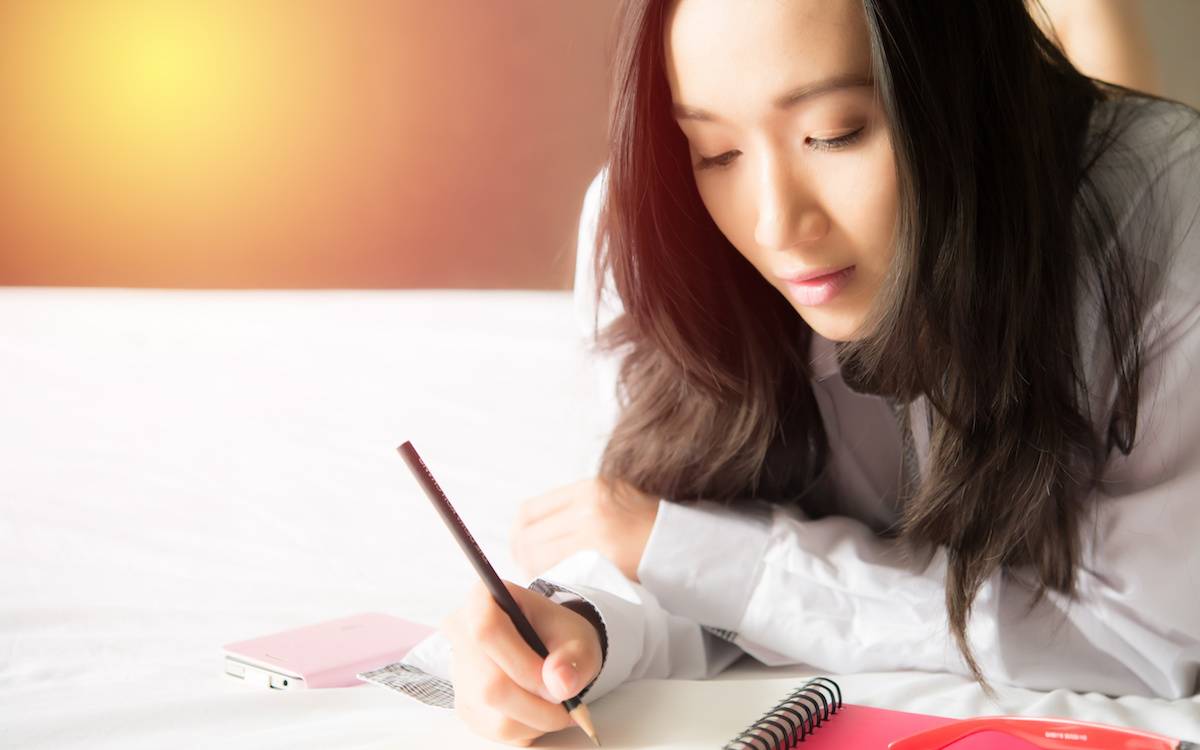 Asian woman writing a Letter.