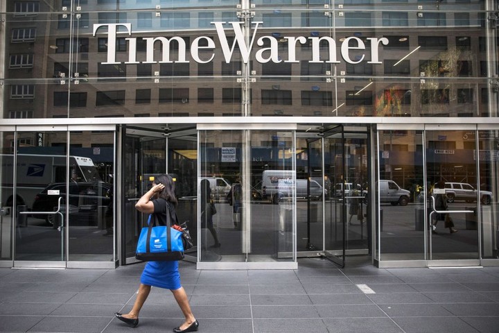 NEW YORK, NY - AUGUST 07: A woman walks past the entrance to the Time Warner center on August 7, 2013 in New York City. The media company reported a 87 percent jump in second-quarter earnings of $771 million, compared with $413 million in last year's same period. (Photo by Andrew Burton/Getty Images)