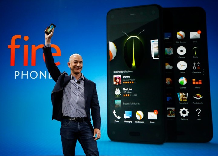 Amazon CEO Jeff Bezos holds up the new Amazon Fire Phone at a launch event, Wednesday, June 18, 2014, in Seattle. (AP Photo/Ted S. Warren)